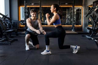 Trainer guiding client workout